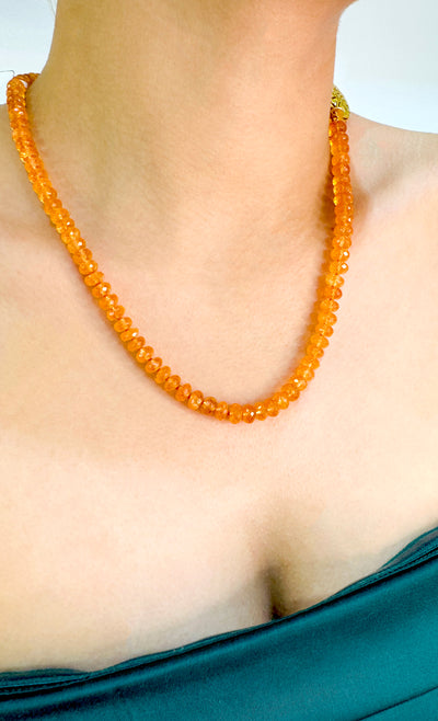 Mendarine Garnet Necklace In 18K Yellow Gold - Tresor Collection Side view of orange moonstone beaded necklace with gold medallion on model – luxury gemstone jewelry