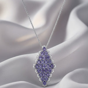 Purple gemstone pendant necklace on a soft fabric background