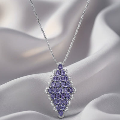 Purple gemstone pendant necklace on a soft fabric background