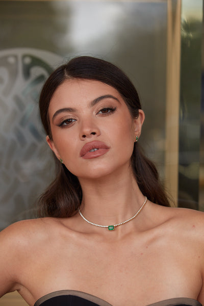 Emerald & Diamond Tennis Necklace In 18K Yellow Gold - Tresor Collection 18K gold emerald and diamond necklace front view on model – luxury statement jewelry by Tresor Collection