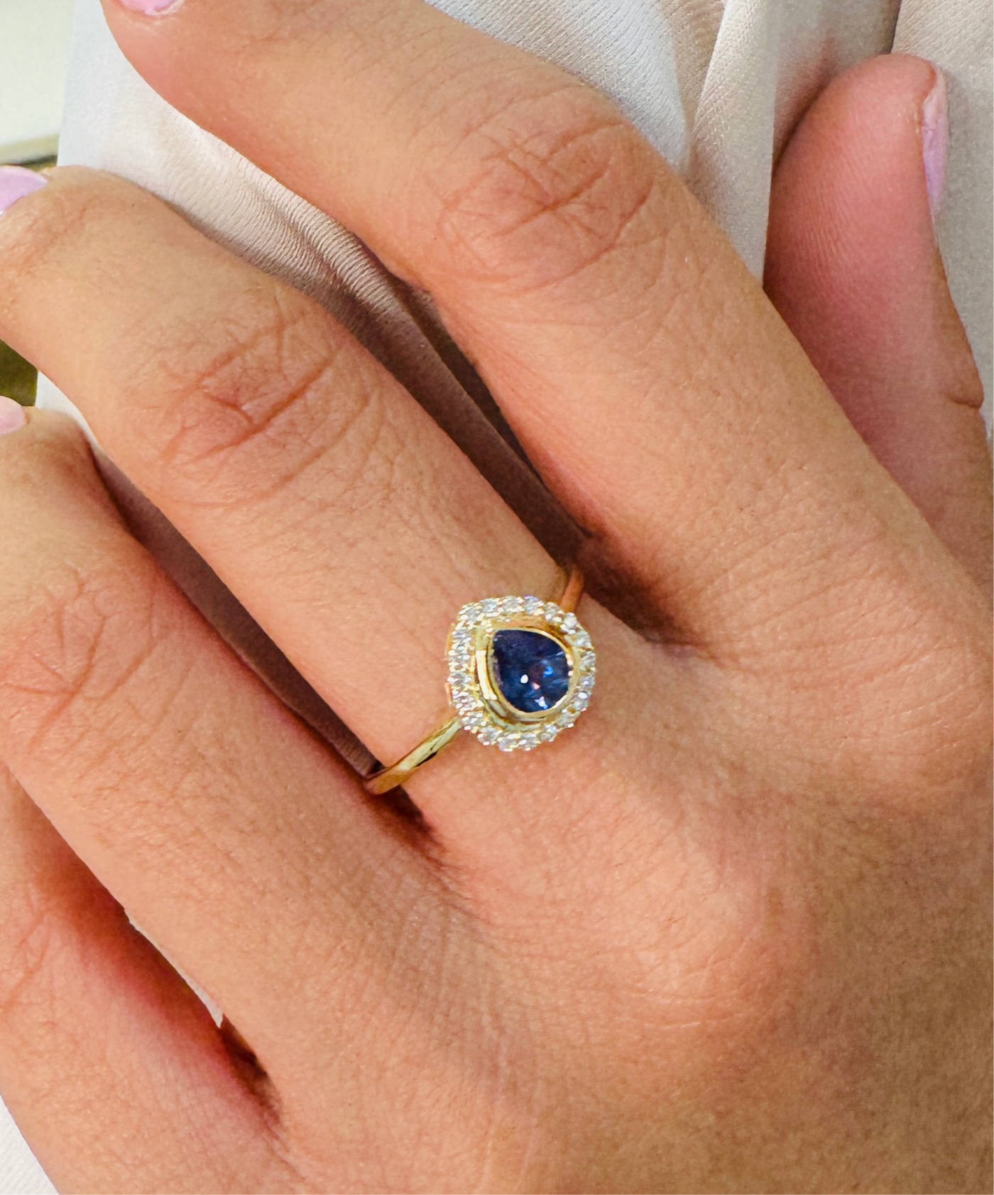 18K gold blue sapphire and diamond ring on model’s hands – sophisticated fine jewelry by Tresor Collection