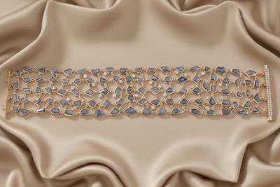 Decorative bracelet with blue stones on beige satin fabric Diamond bracelet displayed on silk fabric – premium handcrafted fine jewelry