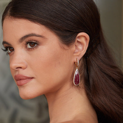 Model wearing ruby and diamond teardrop earrings in 18k yellow gold – Tresor Collection fine jewelry Miami