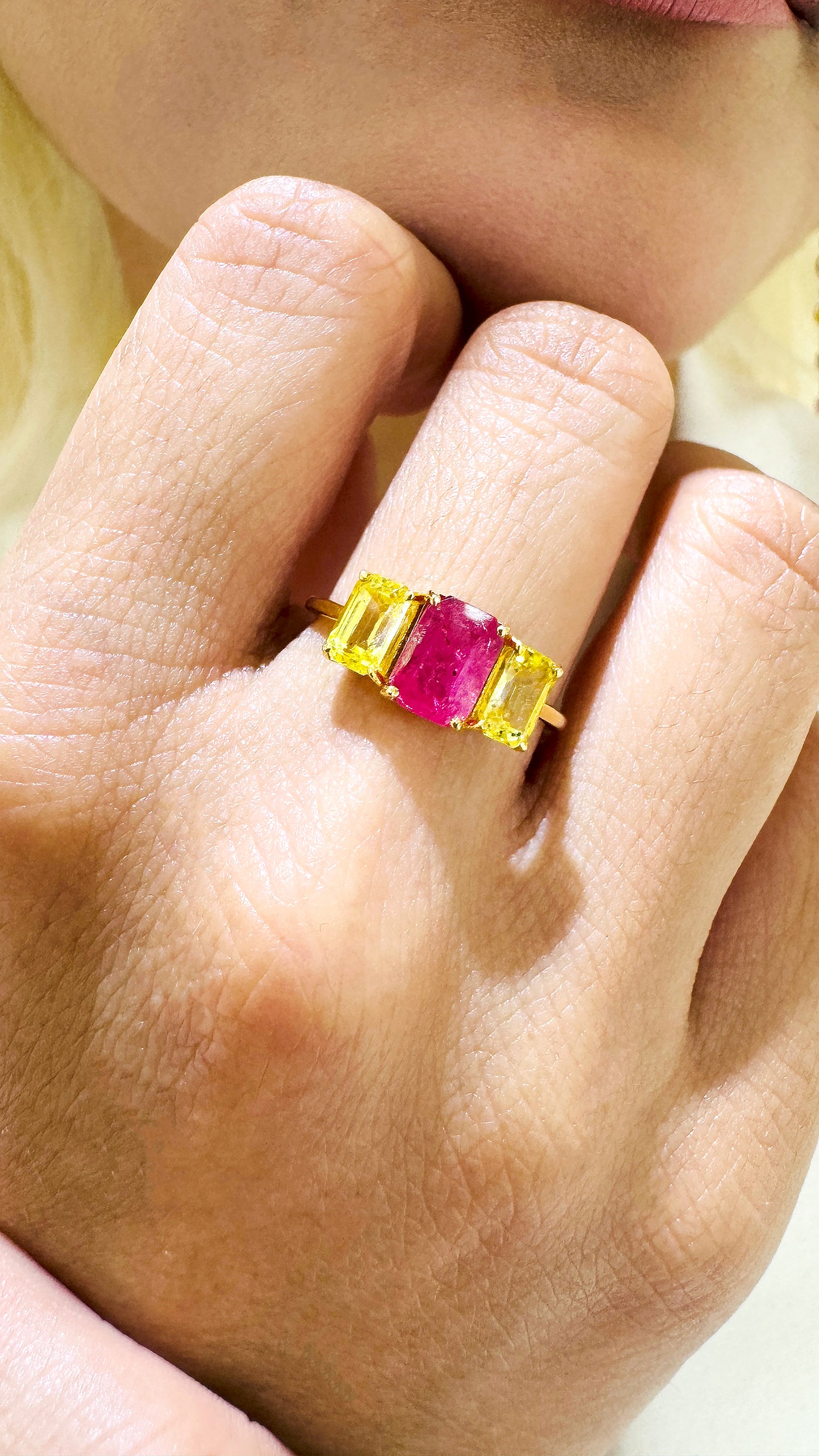 Ruby And Yellow Sapphire Rectangle Ring In 18K Yellow Gold - Tresor Collection Ruby and yellow sapphire gold ring on model’s hand – elegant three-stone gemstone ring by Tresor Collection