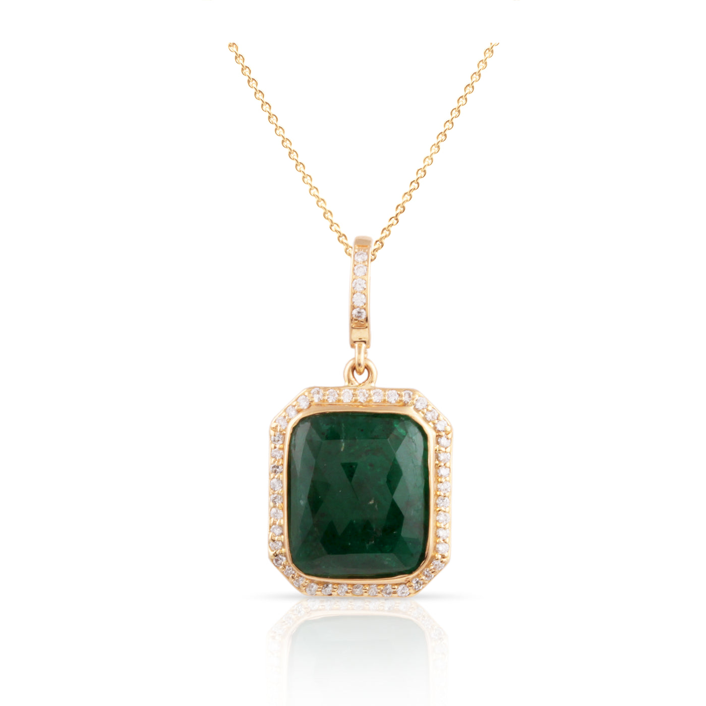 An emerald rectangle and diamond pendant in 18K yellow gold, featuring a gold chain and a yellow gold pendant. 18K gold emerald diamond pendant flatlay – handcrafted fine jewelry by Tresor Collection