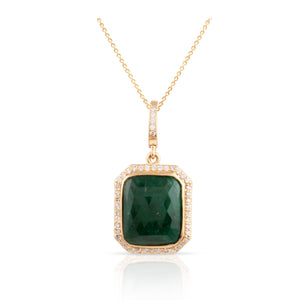 An emerald rectangle and diamond pendant in 18K yellow gold, featuring a gold chain and a yellow gold pendant. 18K gold emerald diamond pendant flatlay – handcrafted fine jewelry by Tresor Collection