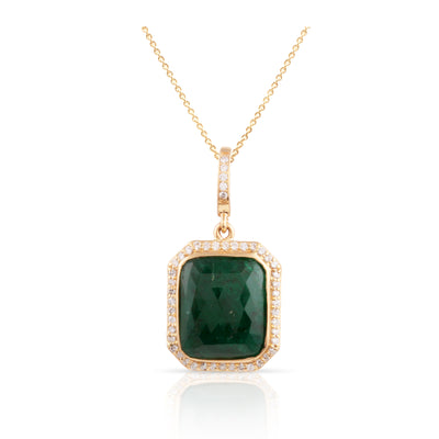 An emerald rectangle and diamond pendant in 18K yellow gold, featuring a gold chain and a yellow gold pendant. 18K gold emerald diamond pendant flatlay – handcrafted fine jewelry by Tresor Collection