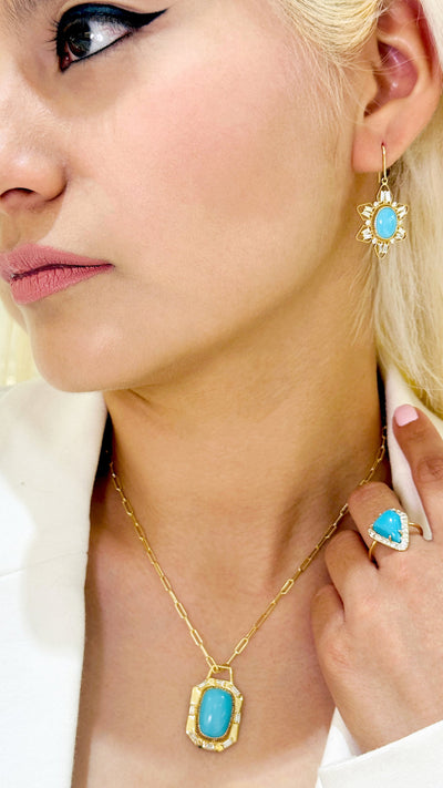 Turquoise Oval & Diamond Earring In 18K Yellow Gold - Tresor Collection Model wearing matching 18K gold Turquoise pendant necklace and earrings – elegant gemstone set Close-up of gold turquoise earrings – highlighting the turquoise stones and intricate design.