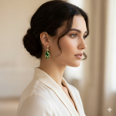Woman wearing green earrings with a neutral background