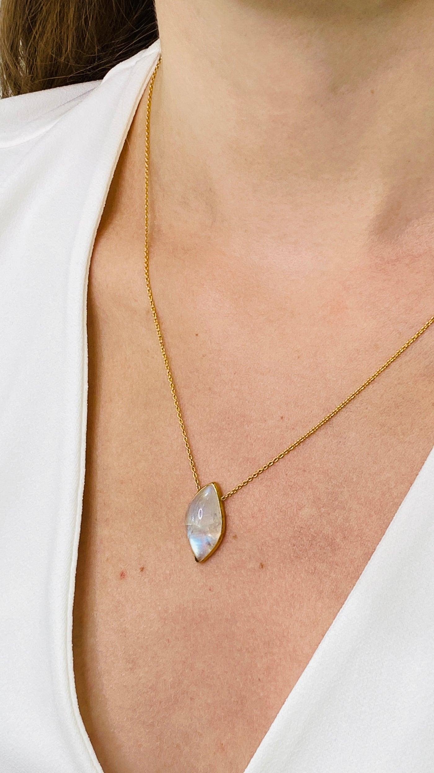 Rainbow Moonstone Necklace In 18K Yellow Gold - Tresor Collection 18K gold moonstone pendant necklace worn on model – elegant iridescent gemstone jewelry