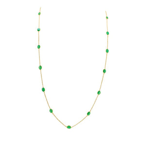 Gold necklace with green gemstones on a white background