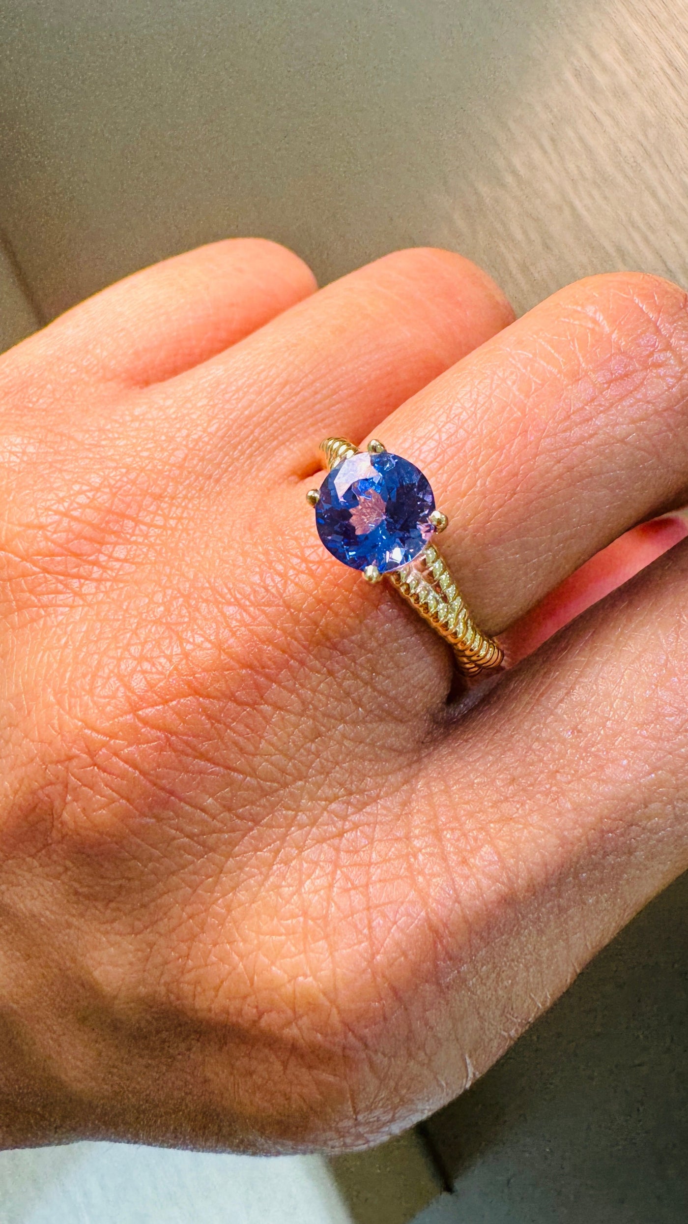 Tanzanite Round Ring In 18K Yellow Gold - Tresor Collection Gold tanzanite ring worn on hand – highlighting the luxurious design and gemstone in motion.