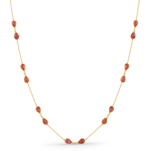 Gold necklace with red beads on a white background 18K gold pink tourmaline necklace flatlay – luxury fine jewelry by Tresor Collection