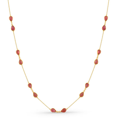 Gold necklace with red beads on a white background 18K gold pink tourmaline necklace flatlay – luxury fine jewelry by Tresor Collection