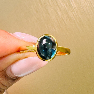 Blue Sapphire Oval Ring In 18K Yellow Gold - Tresor Collection Side view of Blue Sapphire solitaire ring on model – elegant handcrafted gemstone jewelry