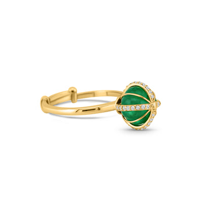 A gold ring featuring a central emerald bead surrounded by smaller beads, with a band of gold metal.