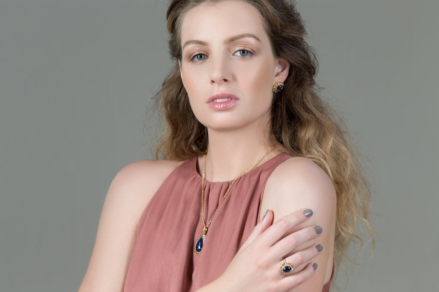 Blue Sapphire And White Topaz Rings In 18K Yellow Gold - Tresor Collection Portrait of model wearing Blue Sapphire and Diamond ring – elegant luxury gemstone jewelry