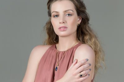 Blue Sapphire And White Topaz Rings In 18K Yellow Gold - Tresor Collection Portrait of model wearing Blue Sapphire and Diamond ring – elegant luxury gemstone jewelry