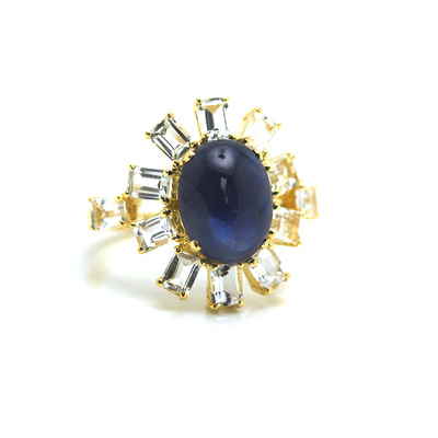 Blue Sapphire And White Topaz Rings In 18K Yellow Gold - Tresor Collection Top view of Blue Sapphire and Diamond halo ring – designer handcrafted gemstone jewelry