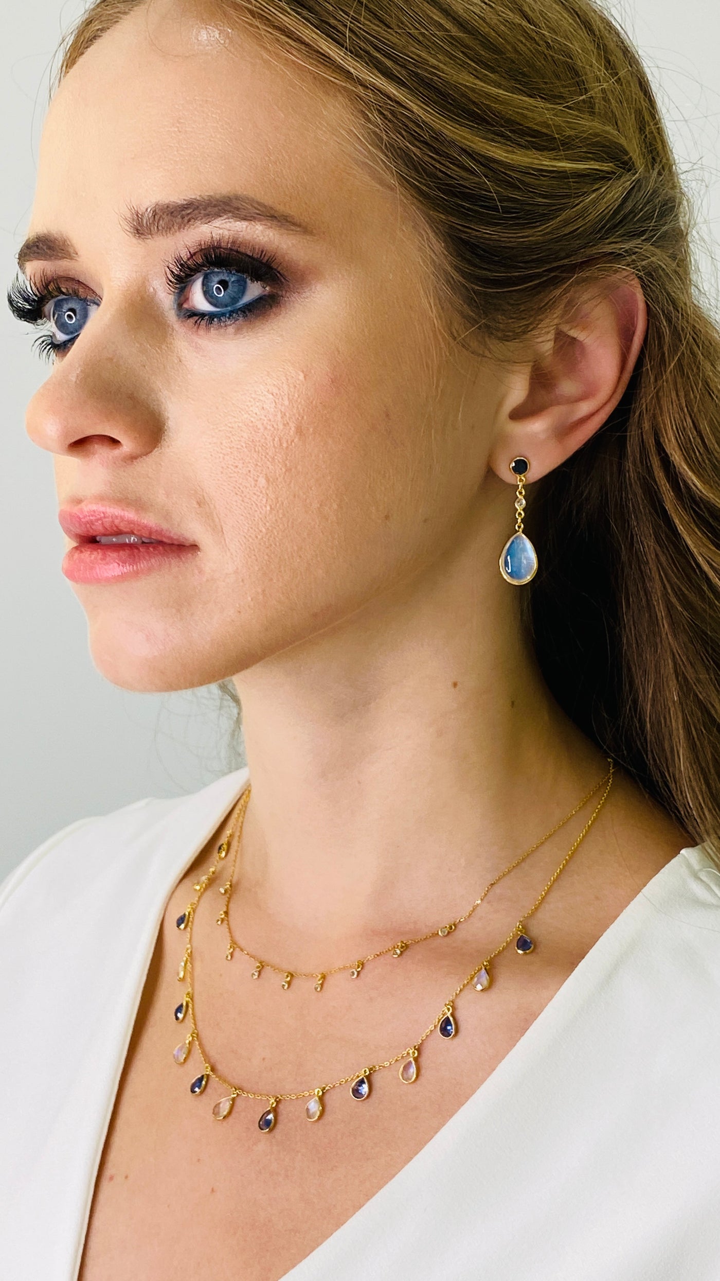 Blue Sapphire Round, Rainbow Moonstone Pear Shape And Diamond Earring In 18K Yellow Gold - Tresor Collection Rainbow Moonstone and Blue Sapphire dangle earrings on model – designer gold jewelry by Tresor Collection
