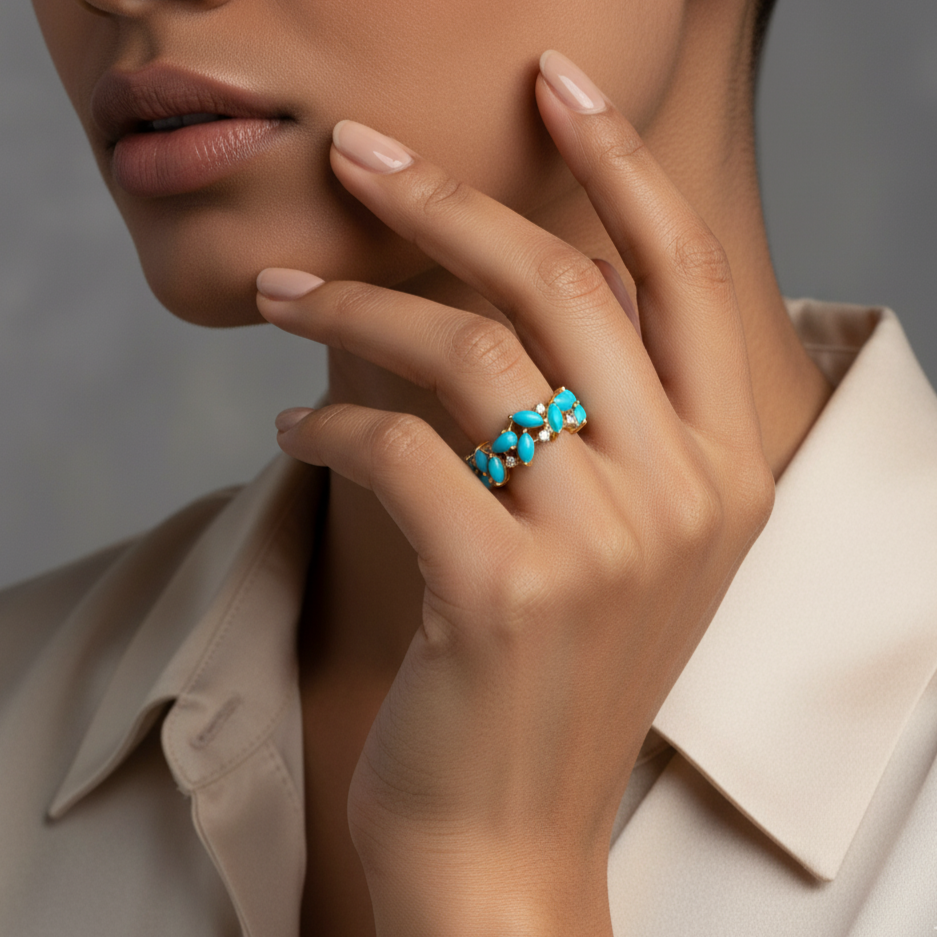 Close-up of a hand wearing a turquoise ring with a neutral background