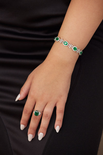 Emerald Oval & Diamond Bracelet In 18K White Gold - Tresor Collection White gold emerald bracelet on wrist – sophisticated green gemstone accessory
