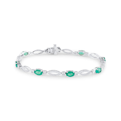 18K White Gold Oval Emerald & Diamond Bracelet by Tresor Collection 18K white gold emerald and diamond tennis bracelet flatlay – luxury handcrafted jewelry by Tresor Collection