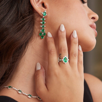 Emerald & Diamond Earring In 18K White Gold - Tresor Collection Elegant woman wearing long emerald and diamond drop earrings – fine statement jewelry by Tresor Collection