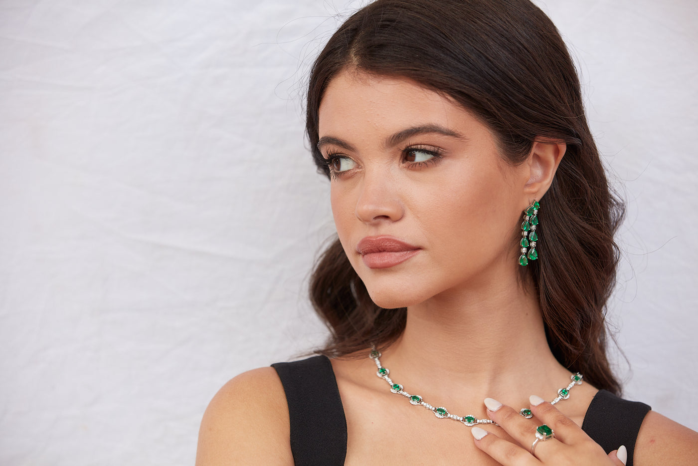 Emerald Pear Shape & Diamond Earring In 18K White Gold - Tresor Collection Model wearing 18K gold emerald and diamond drop earrings – luxury evening jewelry