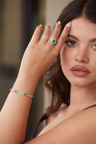 Emerald Oval & Diamond Ring In 18K White Gold - Tresor Collection Model wearing emerald and diamond halo ring – elegant white gold statement jewelry