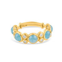 Gold bracelet with blue stones and diamonds on a white background 18K gold aquamarine and diamond ring flatlay – luxury fine jewelry by Tresor Collection