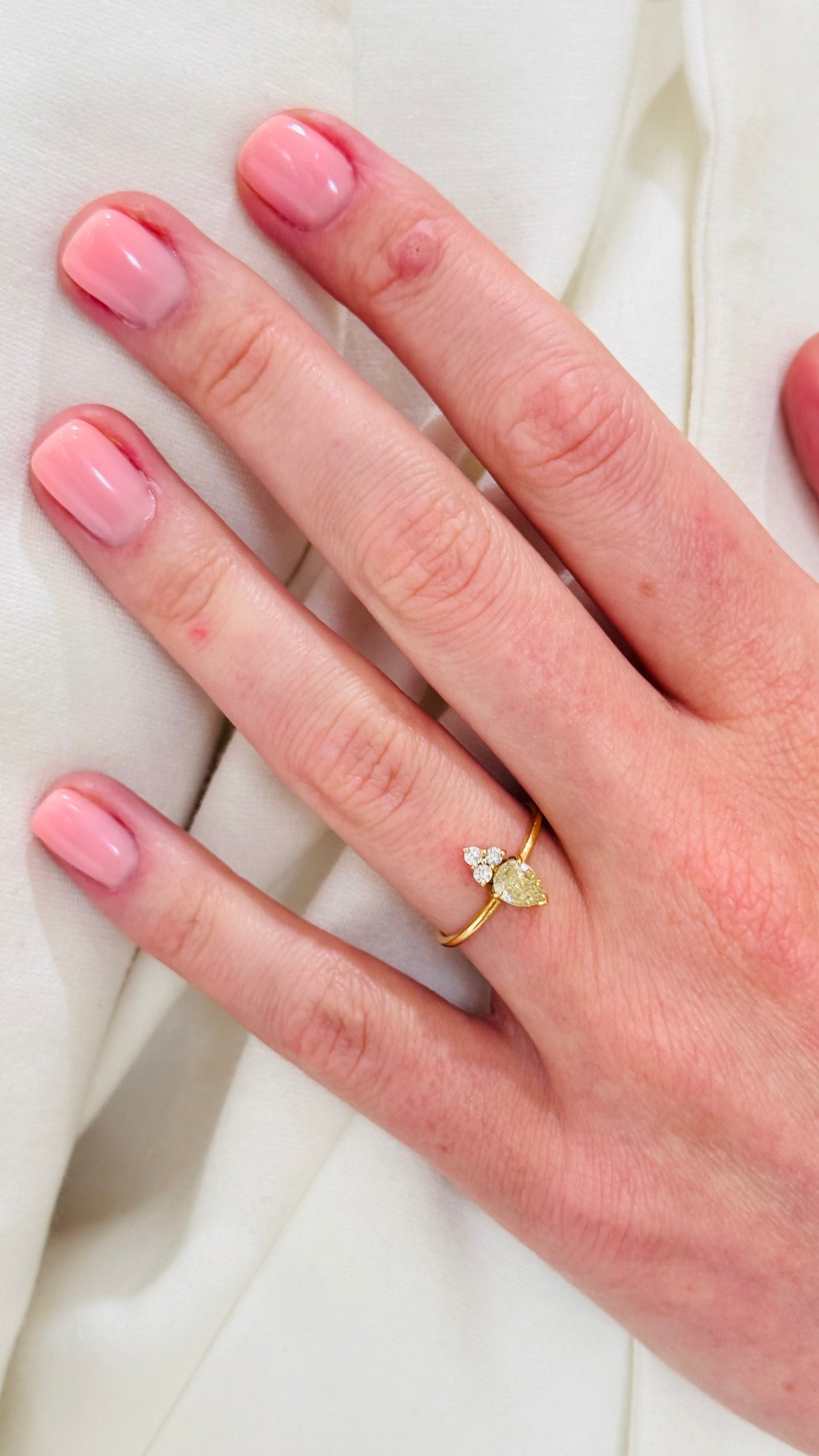 Diamond Pear Shape And Diamond Round Ring In 18K Yellow Gold - Tresor Collection Close-up of yellow diamond gold ring on hand – luxury fine jewelry by Tresor Collection