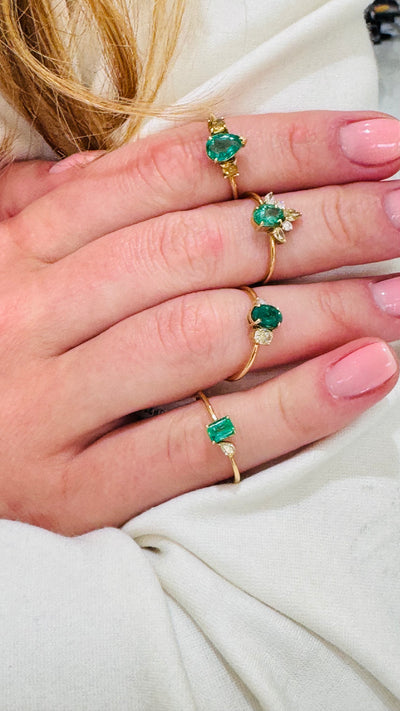 Emerald Oval & Diamond Ring In 18K Yellow Gold - Tresor Collection Gold ring with emerald-cut emerald and pear diamond worn on hand – elegant minimalist gemstone design Stacked emerald and diamond rings on hand – stylish layered jewelry look