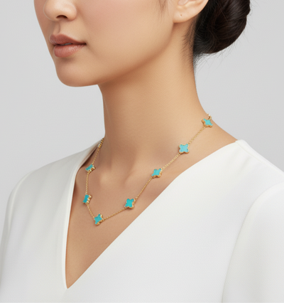 Necklace with turquoise star pendants worn by a model on a plain background