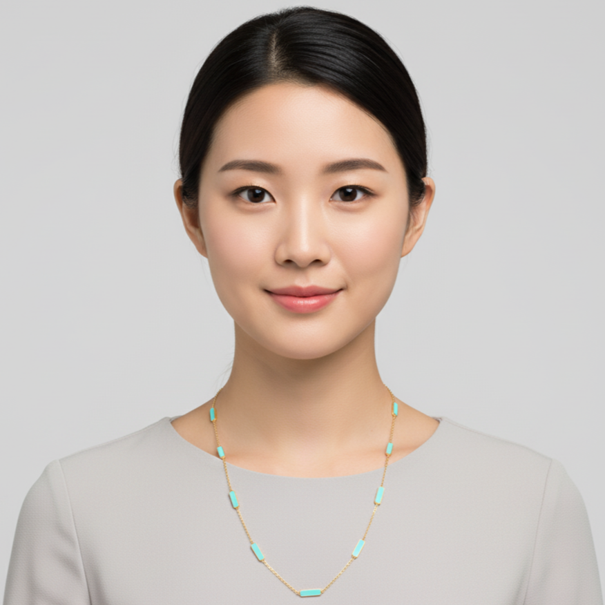 Woman wearing a necklace against a plain background Turquoise necklace styled for festive occasions – modern luxury jewelry by Tresor Collection