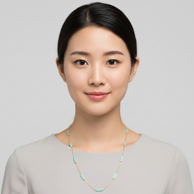 Woman wearing a necklace against a plain background Turquoise necklace styled for festive occasions – modern luxury jewelry by Tresor Collection