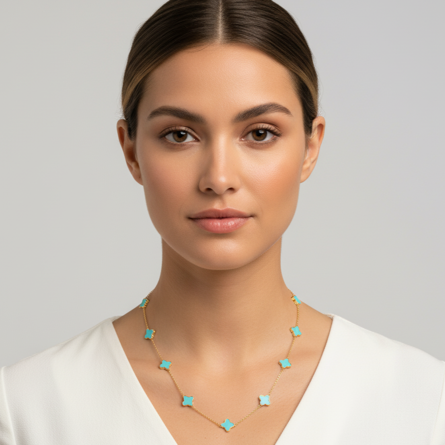 Woman wearing a necklace with turquoise accents against a plain background Turquoise star necklace styled for festive and everyday elegance – luxury handcrafted jewelry from Tresor Collection