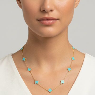 Necklace with turquoise star-shaped pendants on a plain background Elegant turquoise star necklace on model – designer gold jewelry for women by Tresor Collection