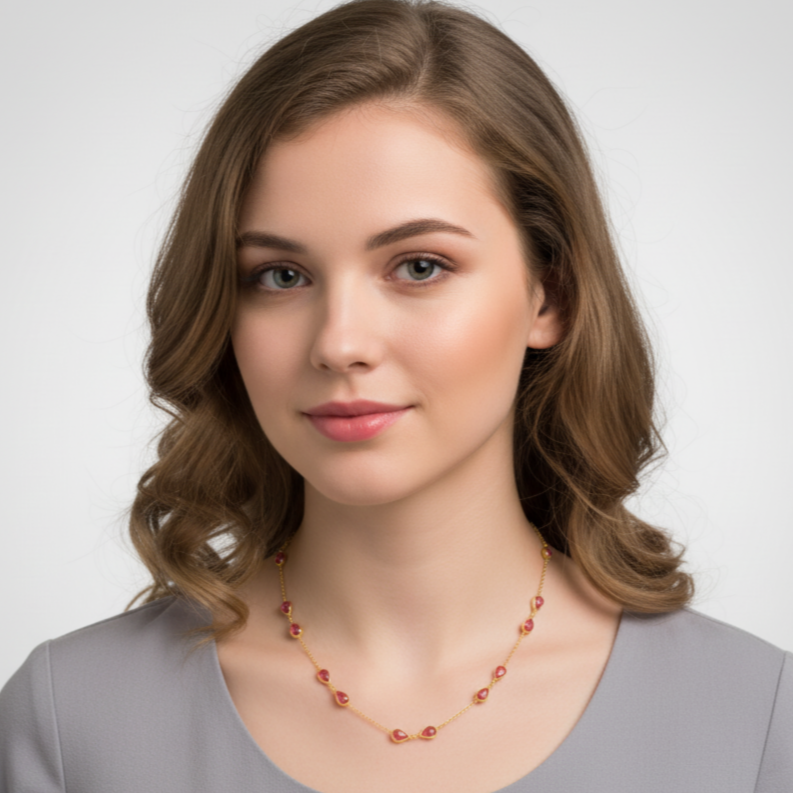 Woman wearing a necklace against a plain background Pink tourmaline necklace styled for festive occasions – luxury handcrafted jewelry from Tresor Collection