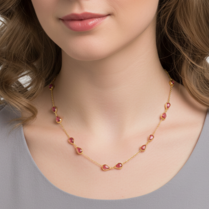 Necklace with red beads worn by a model on a plain background Elegant pink tourmaline necklace on model – designer gold jewelry for women by Tresor Collection