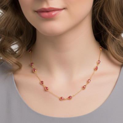 Necklace with red beads worn by a model on a plain background Elegant pink tourmaline necklace on model – designer gold jewelry for women by Tresor Collection