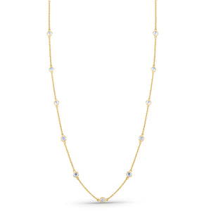 Gold necklace with small gemstones on a white background 18K gold rainbow moonstone necklace flatlay – luxury fine jewelry by Tresor Collection