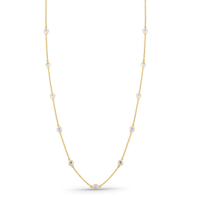 Gold necklace with small gemstones on a white background 18K gold rainbow moonstone necklace flatlay – luxury fine jewelry by Tresor Collection