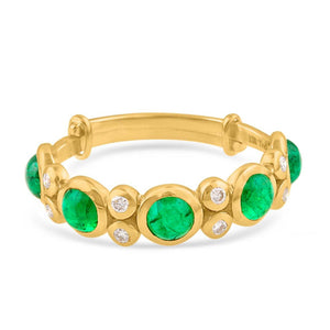 Gold bracelet with green gemstones and diamonds on a white background 18K gold emerald and diamond ring flatlay – luxury fine jewelry by Tresor Collection