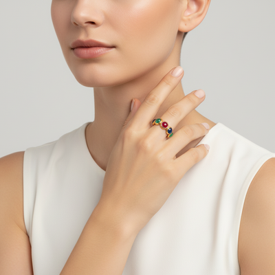 Woman wearing a ring with colored stones on a plain background Mosaico ring styled for festive and gifting occasions – luxury handcrafted gold jewelry from Tresor Collection